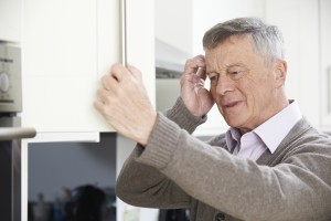 Forgetful Senior Man Looking In Cupboard