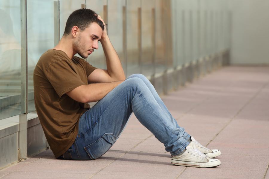 Adolescent with Lyme disease and depression holding his head