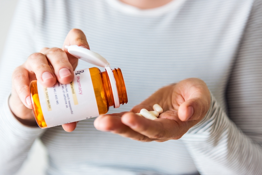 Woman taking antibiotic pills