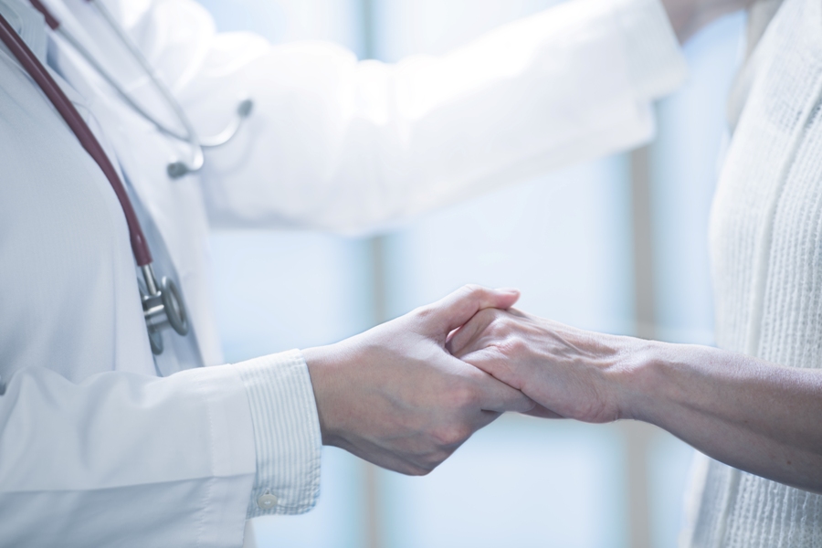 Lyme literate doctor holding hands with patient.