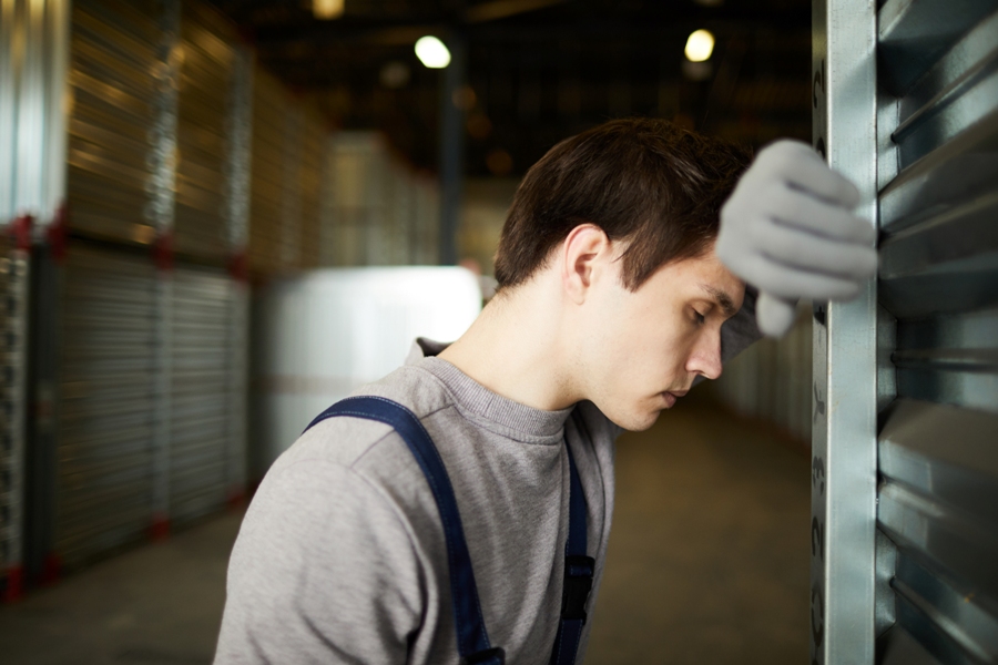 tired young man leaning on wall who has heart block from lyme disease