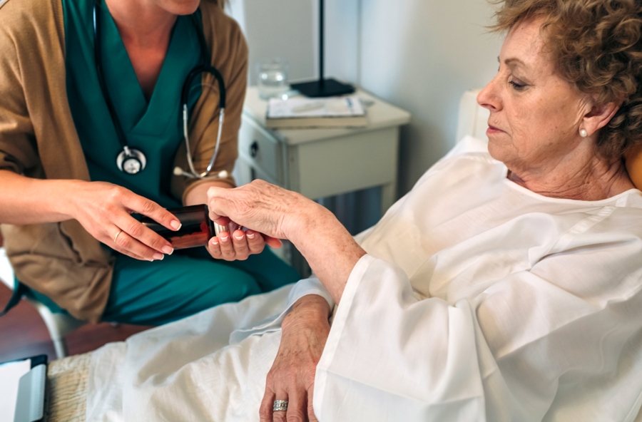 woman with geriatric babesia receiving medication from nurse