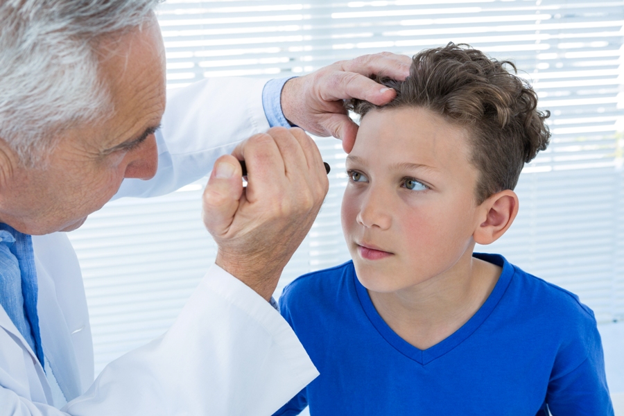 doctor examine boy with Lyme disease in the eye