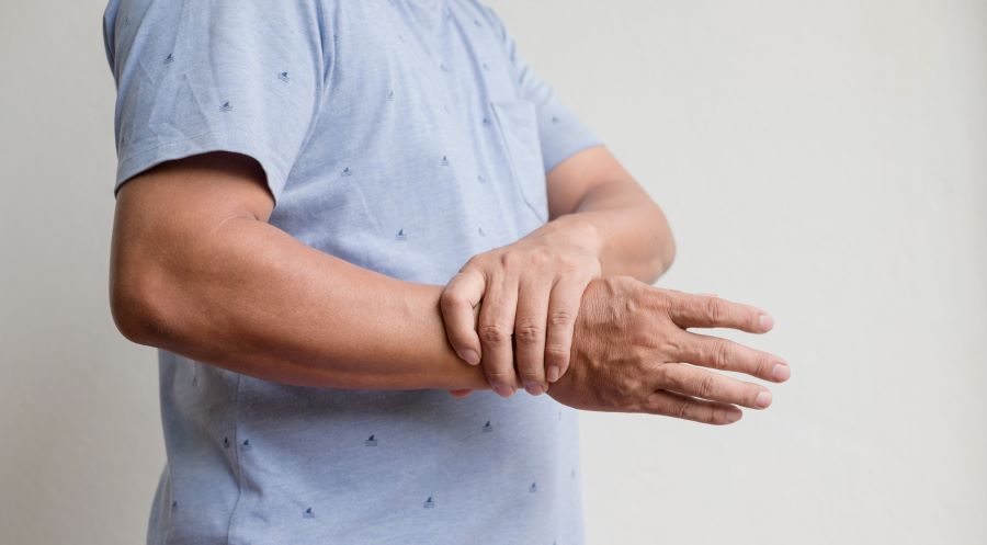 Man with lyme arthritis rubbing his wrist.