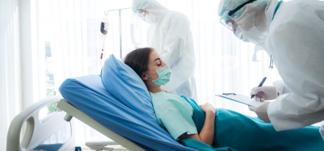 Woman with Lyme disease and COVID-19 being examined in hospital bed.