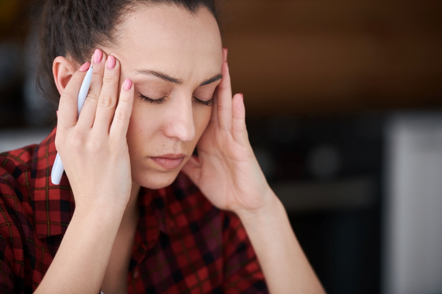 woman with Lyme disease symptoms long term has headacheding her head