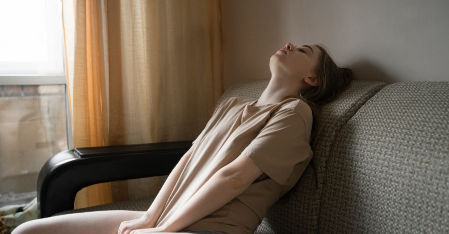 woman resting on couch sunlight chronic illness