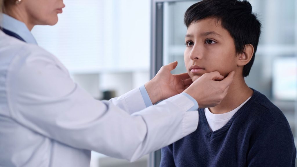 pediatric doctor evaluating facial weakness in child possible Lyme disease