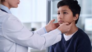 pediatric doctor evaluating facial weakness in child possible Lyme disease