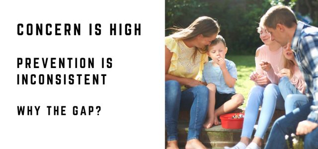Parents checking their child after outdoor activity, illustrating the gap between Lyme disease concern and prevention