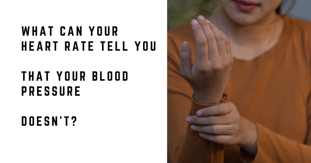 Woman checking her pulse at her wrist while sitting at home