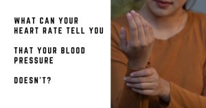 Woman checking her pulse at her wrist while sitting at home