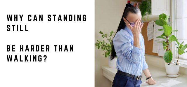 Woman feeling unwell while standing and using a desk for support