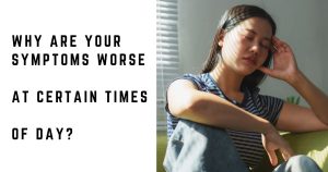 Woman feeling tired and unwell while sitting on a sofa during the day