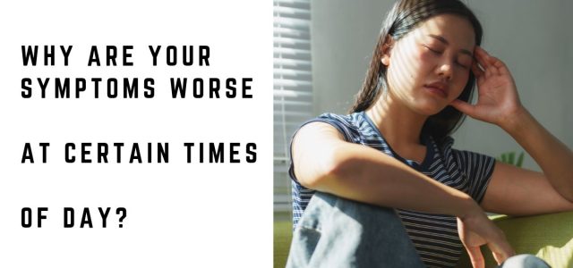 Woman feeling tired and unwell while sitting on a sofa during the day